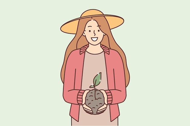 Smiling woman with soil and seedling