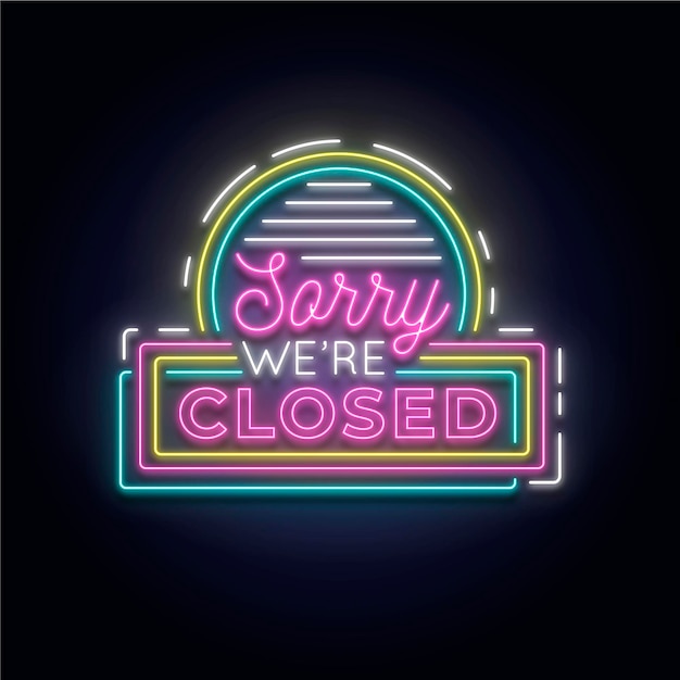 'sorry we are closed' sign on brick wall