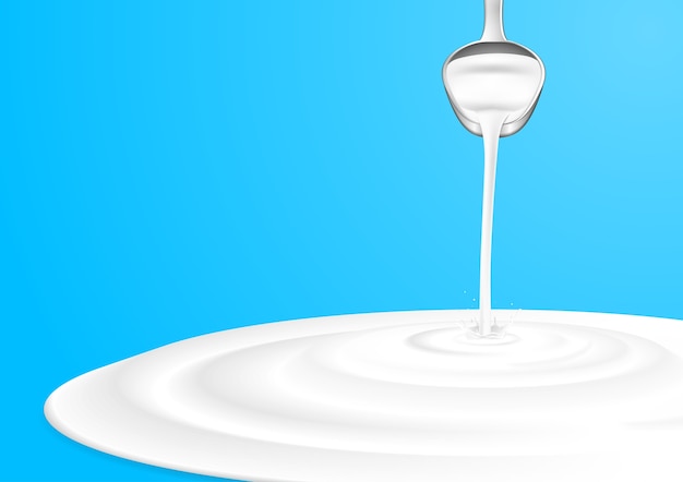 Spoon and pouring cream on blue background