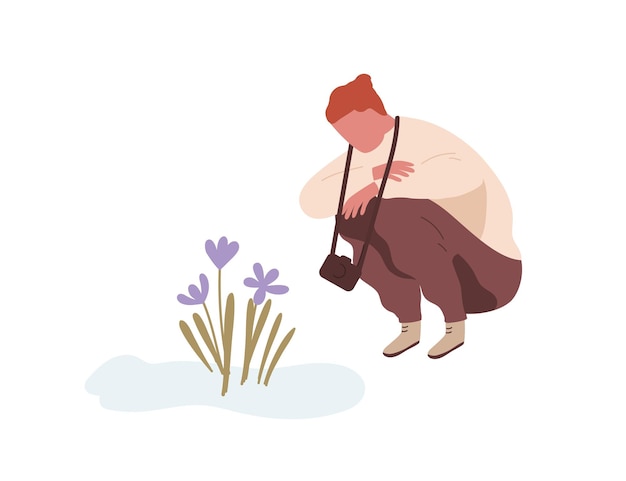 Squatting man admiring first spring flower or snowdrop. Teenager with camera sitting and looking at primrose. Flat vector cartoon illustration isolated on white background.