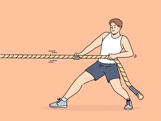 Strong man pulls rope while participating in sports competitions with rivals or training in fitness club Strongman pulls rope alone wanting to win tournament and get prize cup or medal