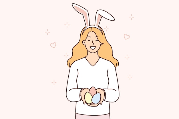 Teenage girl with rabbit ears on head holds Easter eggs prepared for religious Christian holiday