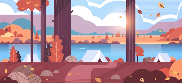 tents camping area in forest autumn camp concept sunny day sunrise landscape nature with water mountains and hills 