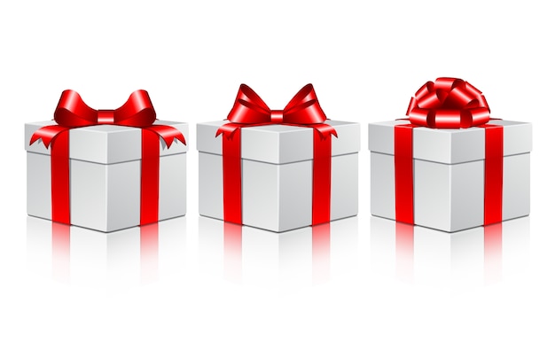 Three white gift boxes with a red bows.