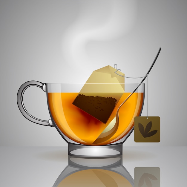 Transparent glass cup with tea bag, spoon and hot water