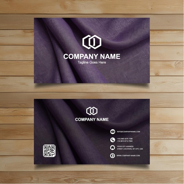 two business cards on a wooden wall with a logo for company company