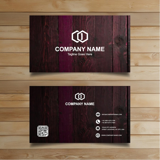 two business cards on a wooden wall with a sign that says company name on it