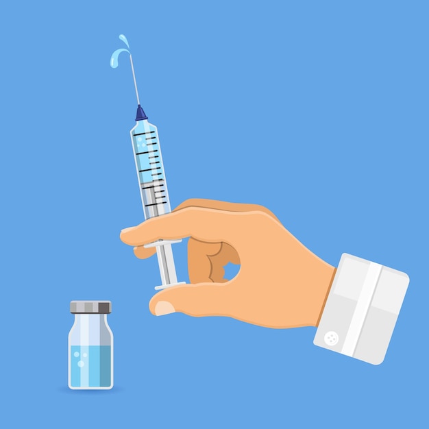 Vaccination with syringe and vaccine in doctor hand