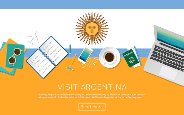 Visit Argentina concept for your web banner or print materials. Top view of a laptop, sunglasses and coffee cup on Argentina national flag. Flat style travel planninng website header.