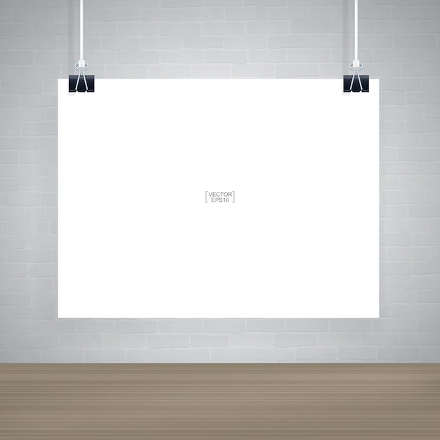 White paper poster hanging on white brick wall in wooden room space