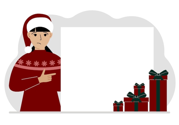 A woman in a Christmas or New Year's sweater with a red sana cap points his finger at a banner a blank poster or a large white sheet of paper with space for text