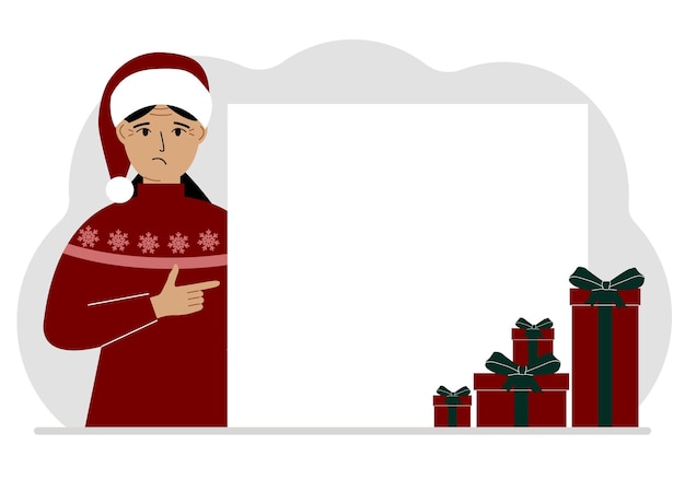 A woman in a Christmas or New Year's sweater with a red sana cap points his finger at a banner a blank poster or a large white sheet of paper with space for text