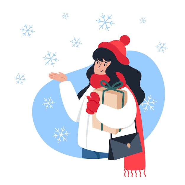 Woman holding a gift and catches snowflakes with her hand, winter walk, Christmas mood