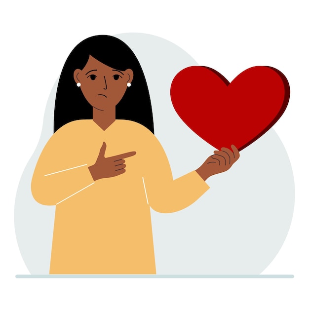 A woman holds a big red heart in his hand The concept of volunteering romantic relationship or love