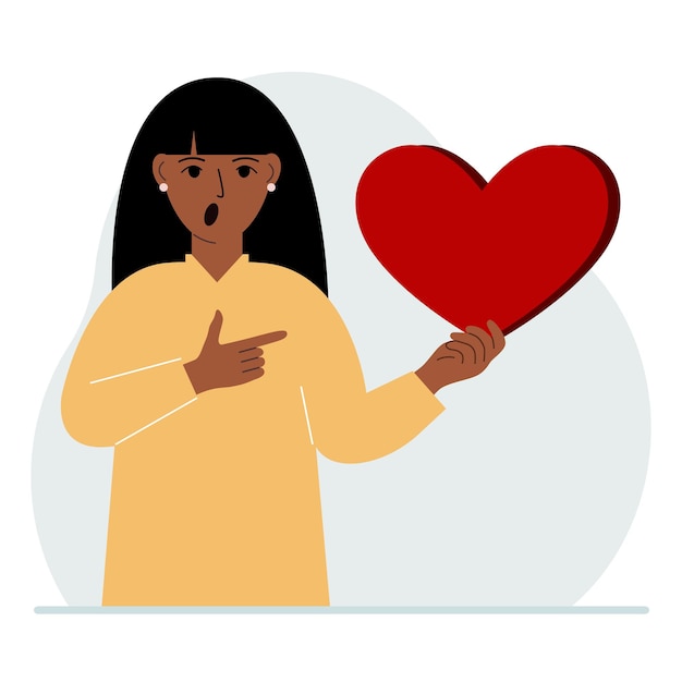 A woman holds a big red heart in his hand The concept of volunteering romantic relationship or love