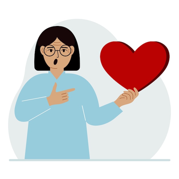 A woman holds a big red heart in his hand The concept of volunteering romantic relationship or love