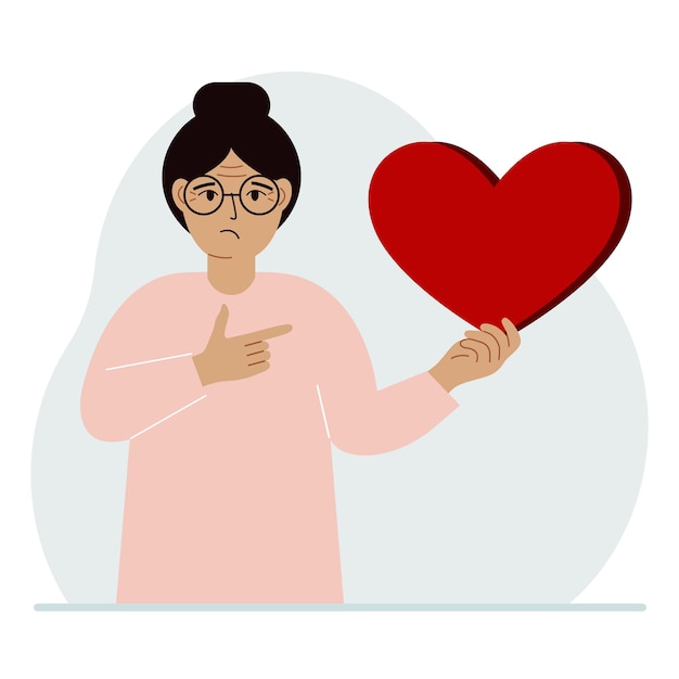 A woman holds a big red heart in his hand The concept of volunteering romantic relationship or love