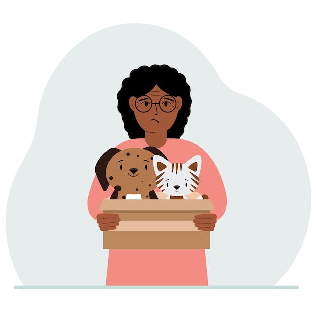 A woman holds a cardboard box with a cat and a dog The concept of rescue help and care for pets