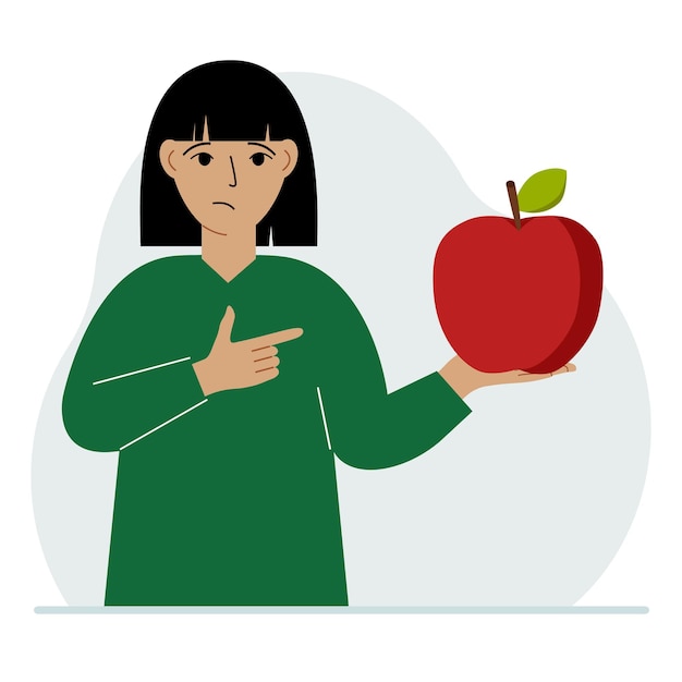 A woman holds a fresh and red apple in his hand Woman eats an apple Healthy food concept