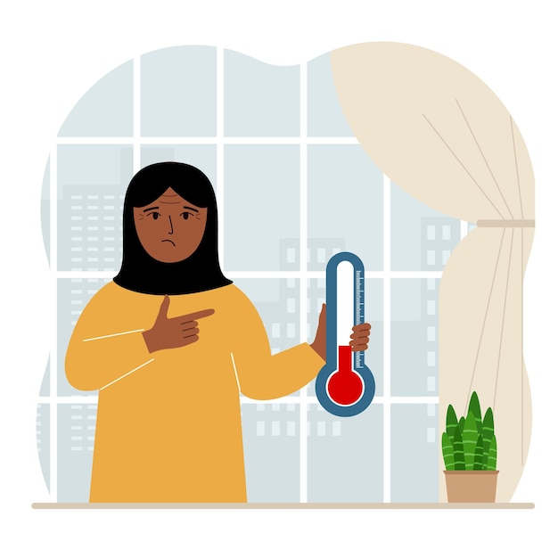 A woman near the window with a device for measuring the temperature in the room