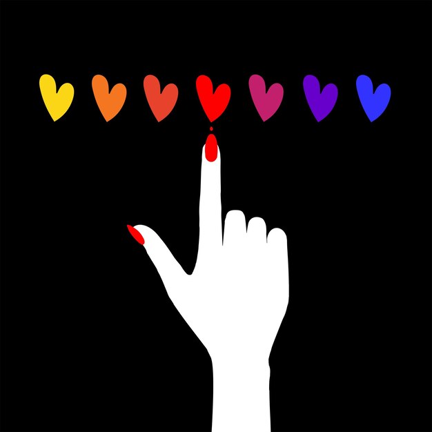 A woman's hand with a manicure chooses a red heart