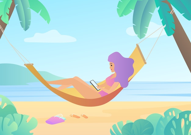 Woman in swimsuit in hammock between palm trees using smartphone and relaxing on beach