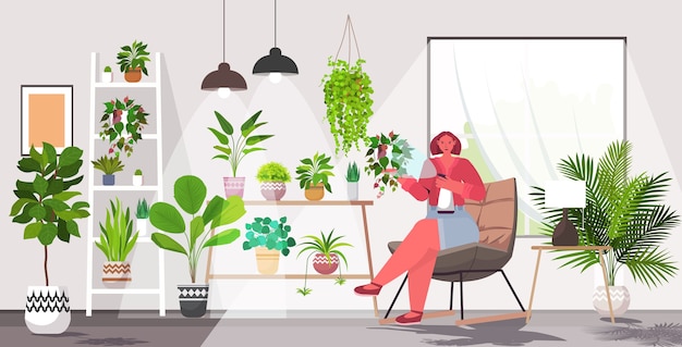 woman taking care of houseplants living room or home garden interior horizontal