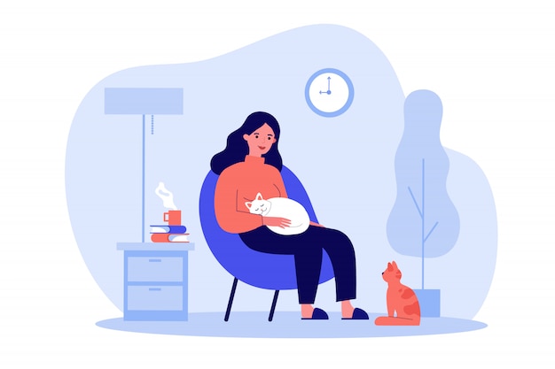 Woman with cats in cozy apartment