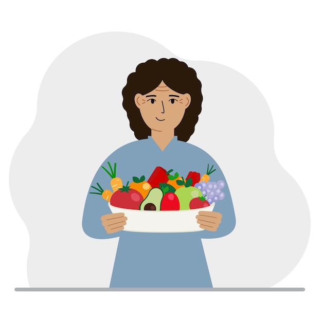 A woman with a large plate of healthy organic food vegetables and fruits The concept of healthy food healthy lifestyle vegetarianism agriculture