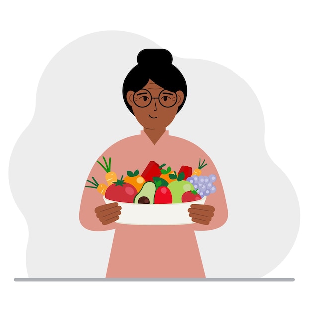 A woman with a large plate of healthy organic food vegetables and fruits The concept of healthy food healthy lifestyle vegetarianism agriculture