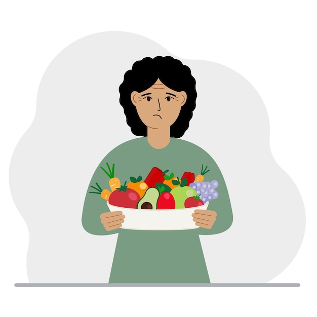 A woman with a large plate of healthy organic food vegetables and fruits The concept of healthy food healthy lifestyle vegetarianism agriculture