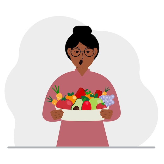 A woman with a large plate of healthy organic food vegetables and fruits The concept of healthy food healthy lifestyle vegetarianism agriculture