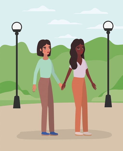 Women holding hands at park 