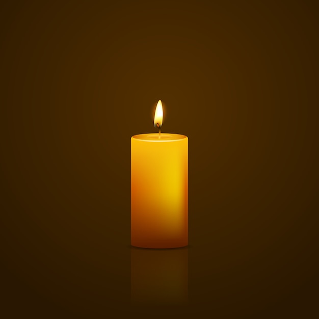 Yellow candle on black background with reflection