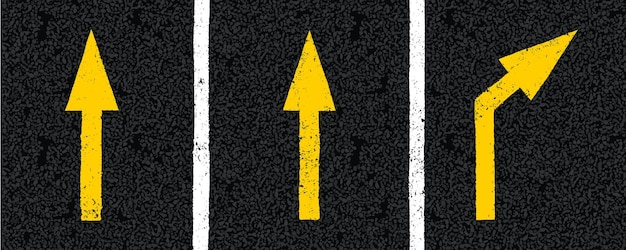 Yellow directional arrow signs on tarmac road top view