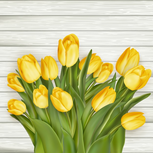 Yellow tulips on wooden background