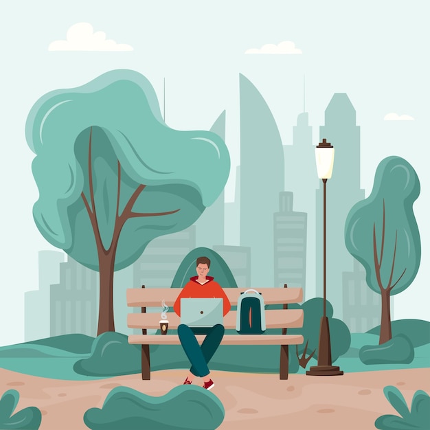 Young man are working on a bench in a city park; freelancer with laptop and coffee.