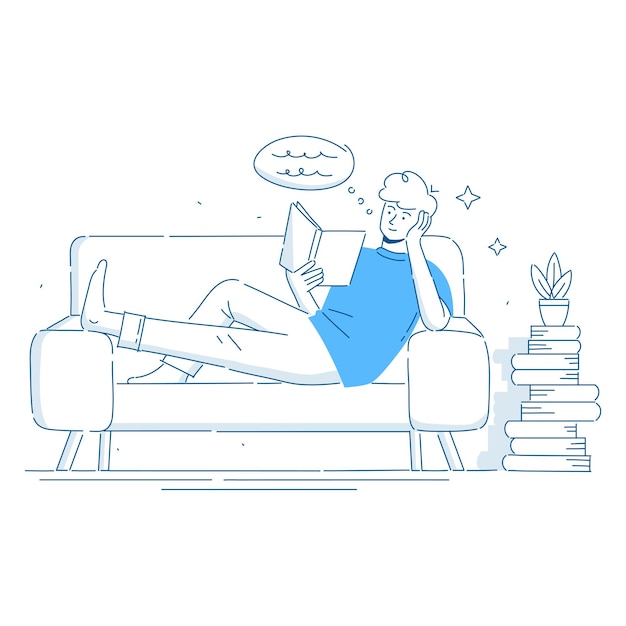 Young man sits in an armchair and reads a book The concept of a cozy reading at home