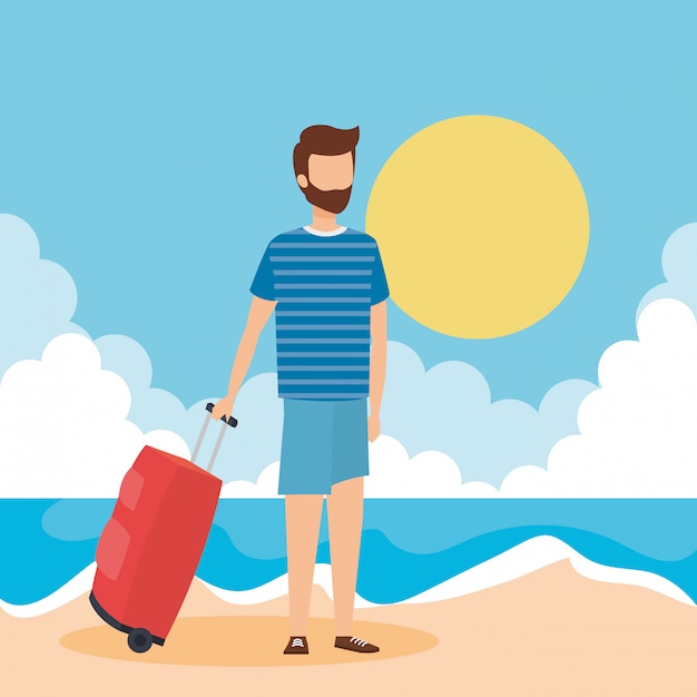 Young man with suitcase on the beach