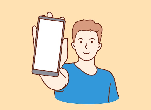 Young smiling man showing smartphone screen with white mockup for text or lettering