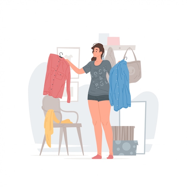 Young woman choosing clothes in morning at home